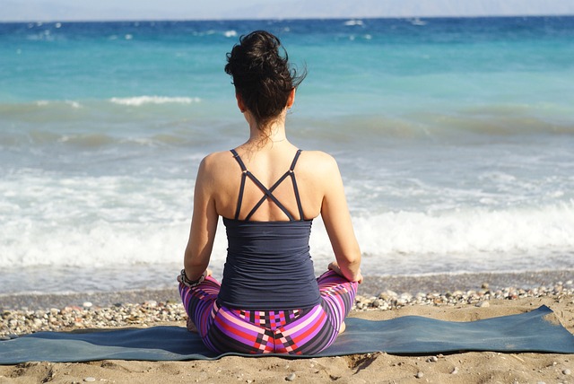 woman meditating on beach